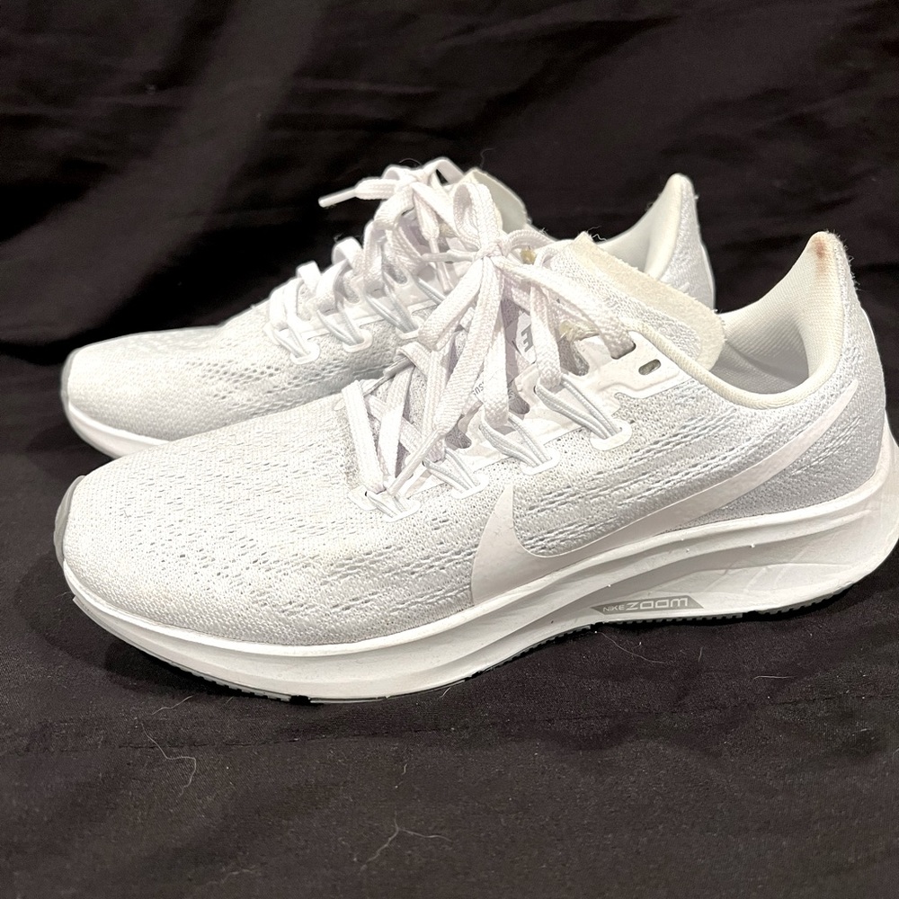 All white Nike womens running shoe